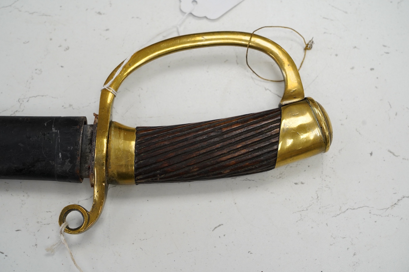A 1920s Persian Cavalry Troopers sword Shashka, based on an 1881 pattern Russian Dragoons sword, in its scabbard numbered 21422, blade 79.5cm. Condition - generally good, scabbard painted black